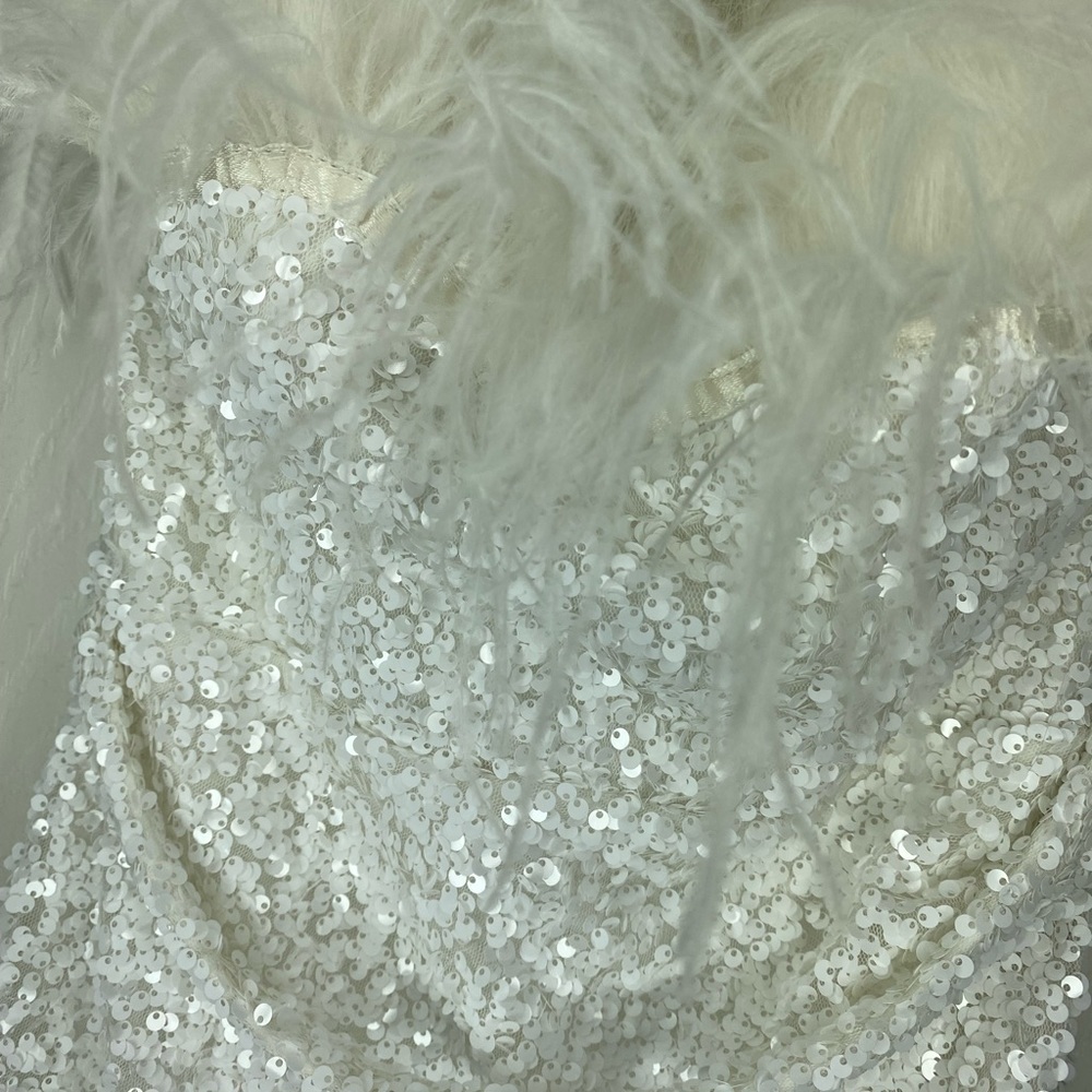 White sequin mini dress with feathers